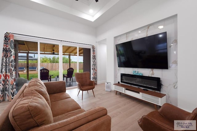9073 New Orleans Ct, Los Fresnos, TX 78566 - living area with wood finished floors, recessed lighting, a high end fireplace, and a high ceiling