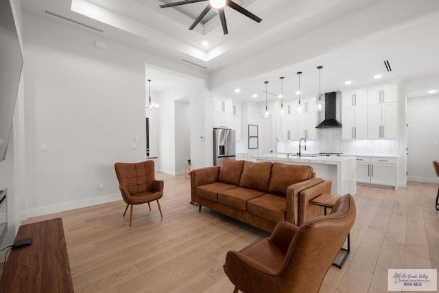 9073 New Orleans Ct, Los Fresnos, TX 78566 - living area featuring a tray ceiling, ceiling fan, light wood finished floors, recessed lighting, and baseboards