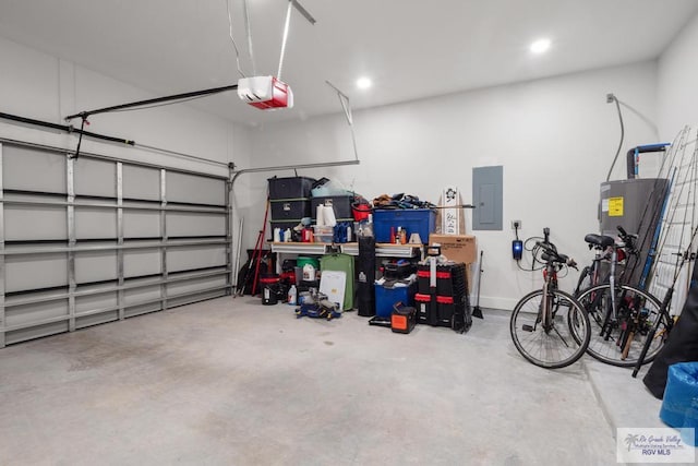 9073 New Orleans Ct, Los Fresnos, TX 78566 - garage with a garage door opener, electric panel, water heater, and recessed lighting