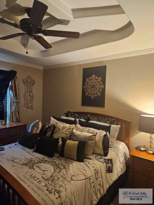 2104 Tomatillo Dr, Weslaco, TX 78596 - bedroom with a raised ceiling, crown molding, and ceiling fan