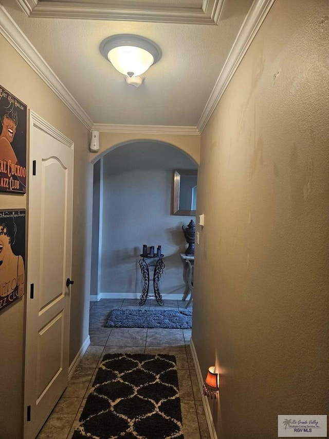 2104 Tomatillo Dr, Weslaco, TX 78596 - hallway featuring arched walkways, ornamental molding, and baseboards