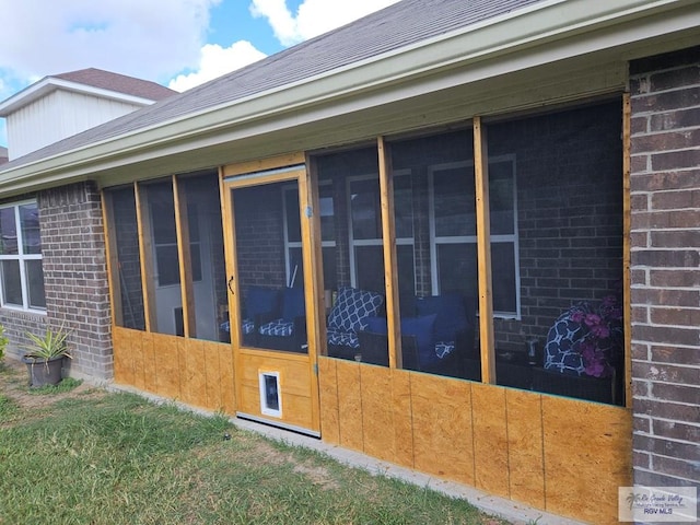 2104 Tomatillo Dr, Weslaco, TX 78596 - view of home's exterior with brick siding, a sunroom, and roof with shingles
