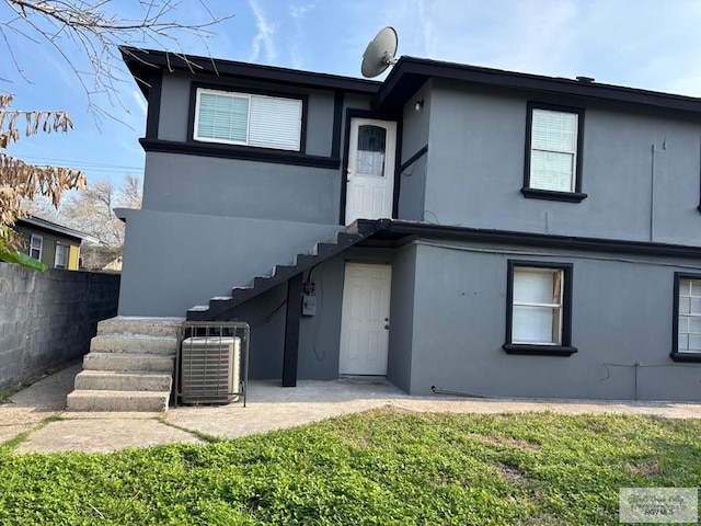 rear view of property featuring central AC