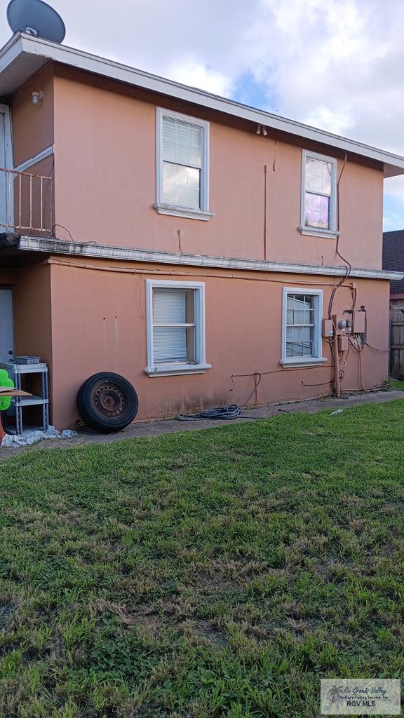 view of side of property with a lawn