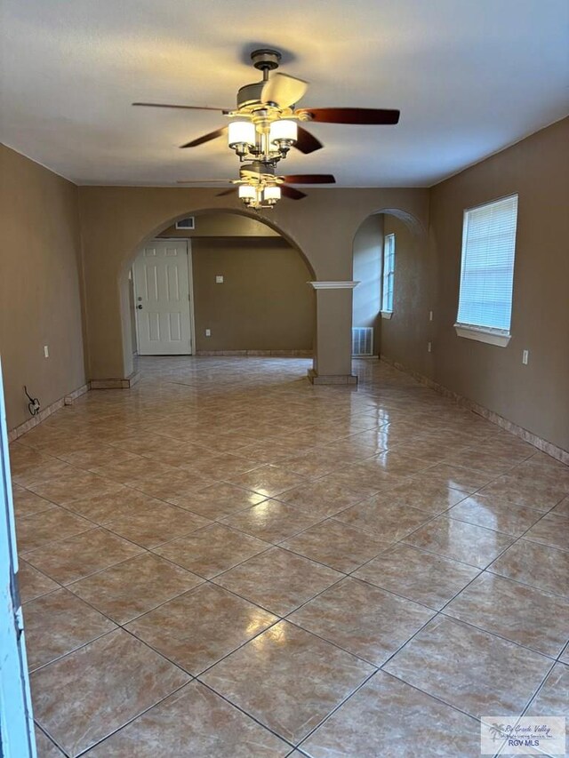 empty room featuring tile patterned floors and electric panel