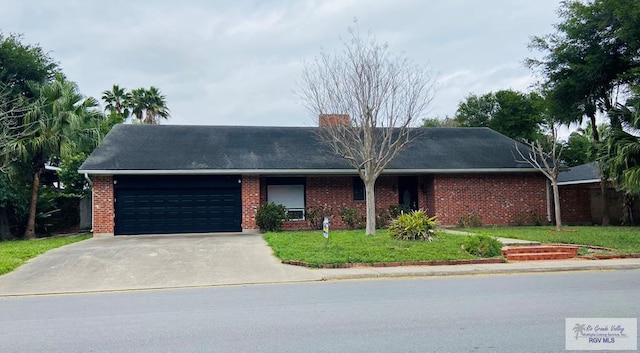 ranch-style home featuring a garage and a front yard