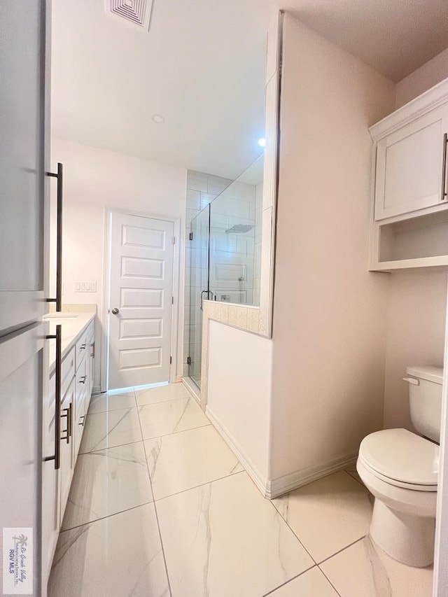 bathroom featuring vanity, toilet, and walk in shower