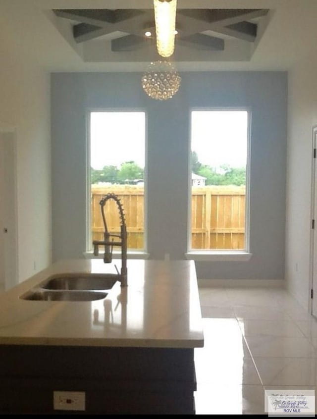 kitchen featuring beamed ceiling, sink, and a wealth of natural light