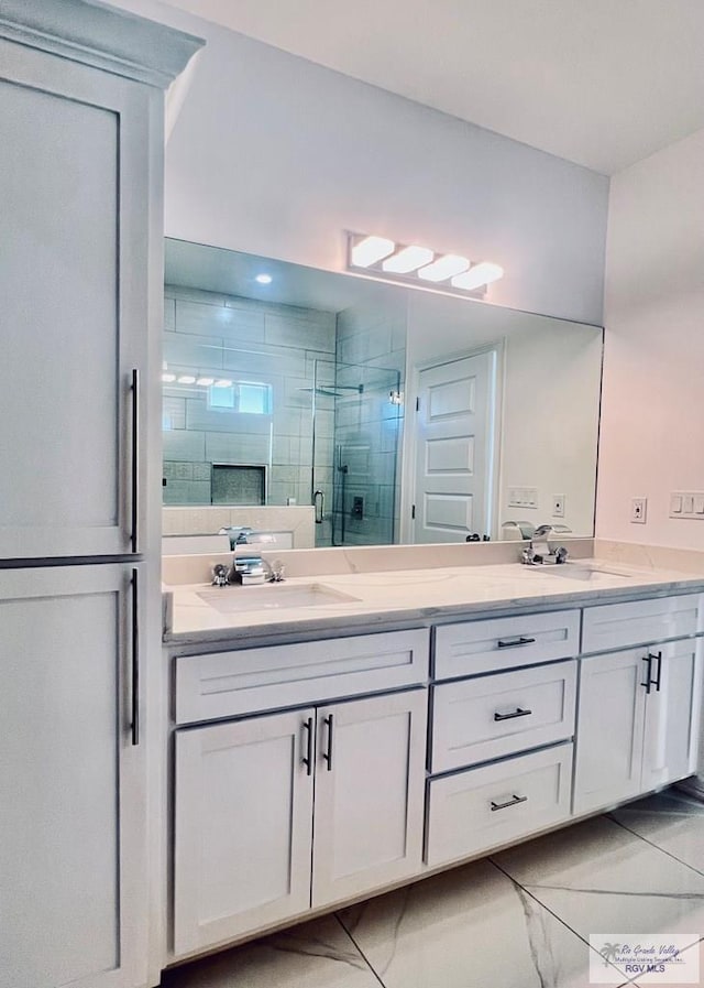 bathroom featuring vanity and a shower with door