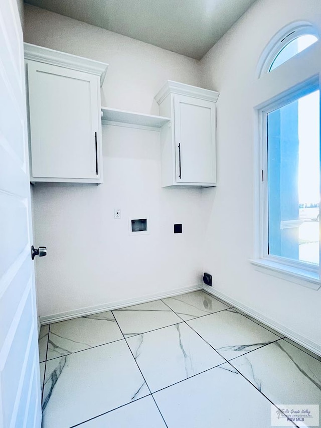 laundry room with electric dryer hookup, washer hookup, and cabinets