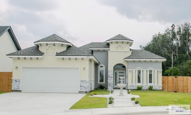 view of front of home with a garage and a front yard