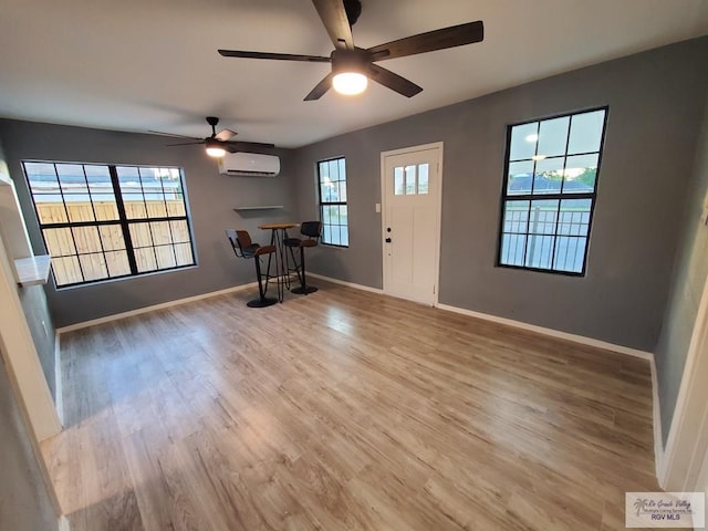 foyer with a wall mounted AC and hardwood / wood-style floors