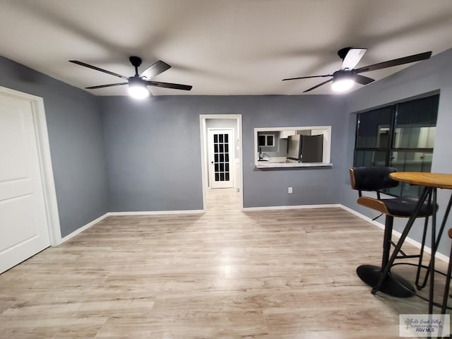 interior space with light hardwood / wood-style floors and ceiling fan