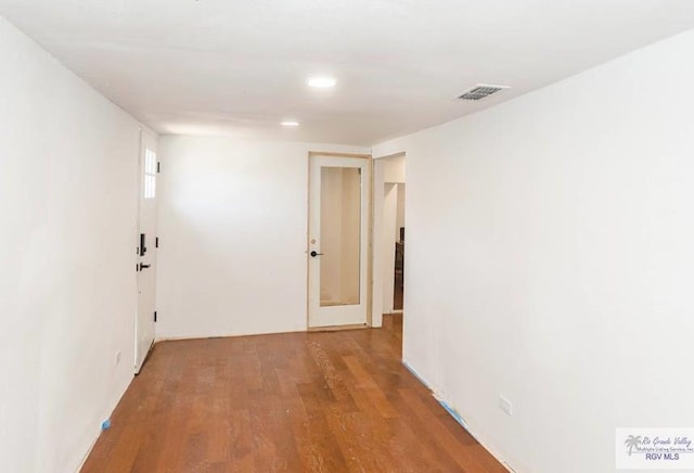 corridor with hardwood / wood-style floors