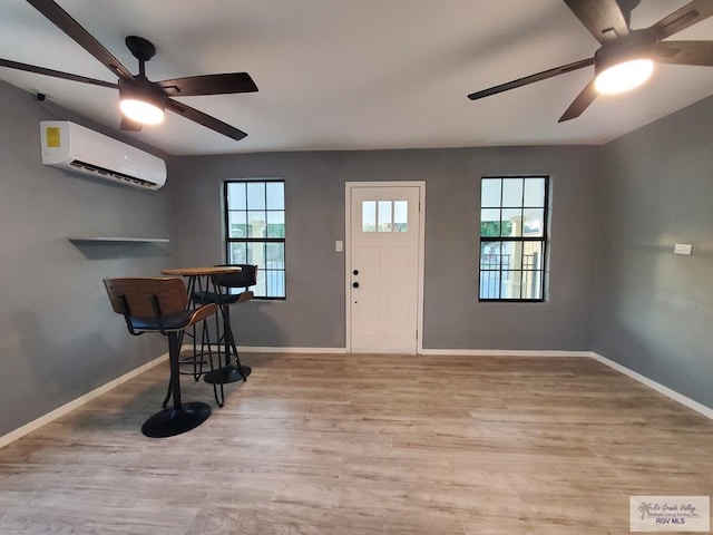 entryway featuring plenty of natural light, a wall unit AC, and light wood-type flooring