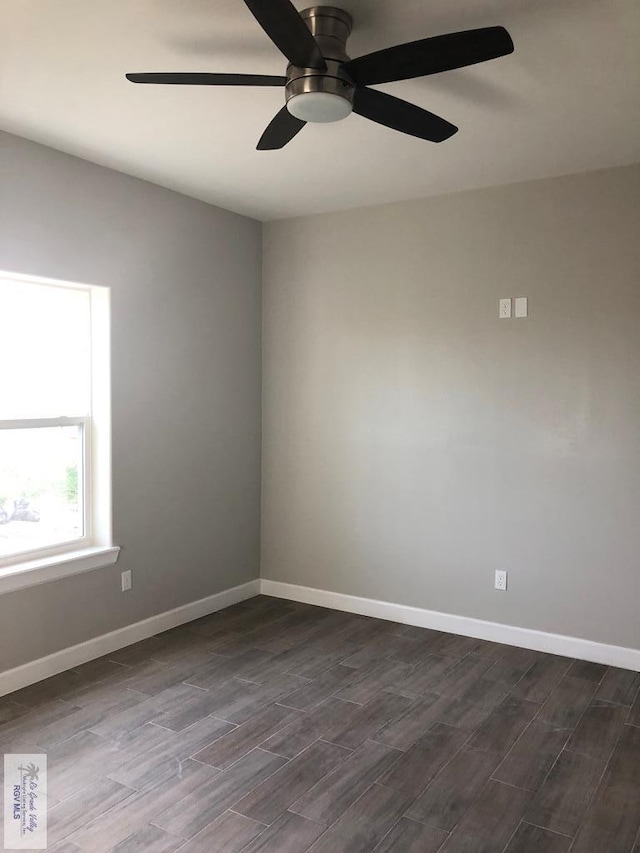 spare room featuring ceiling fan and dark wood-type flooring