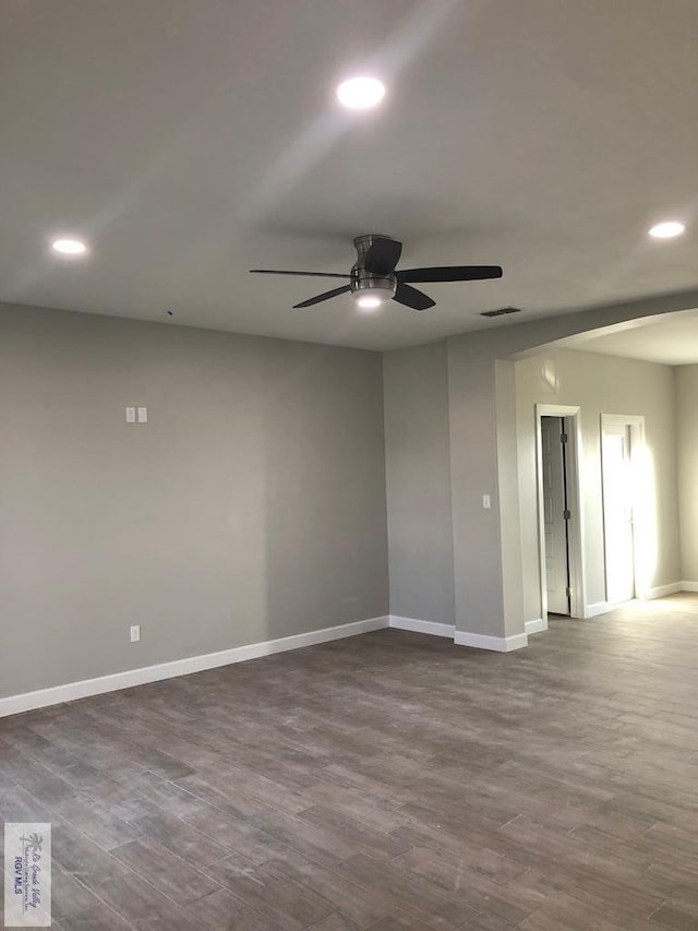 empty room featuring ceiling fan and hardwood / wood-style floors