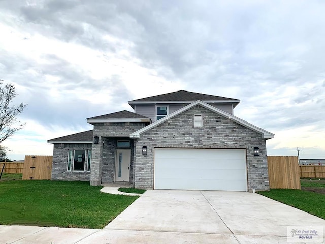 view of front facade with a garage and a front lawn