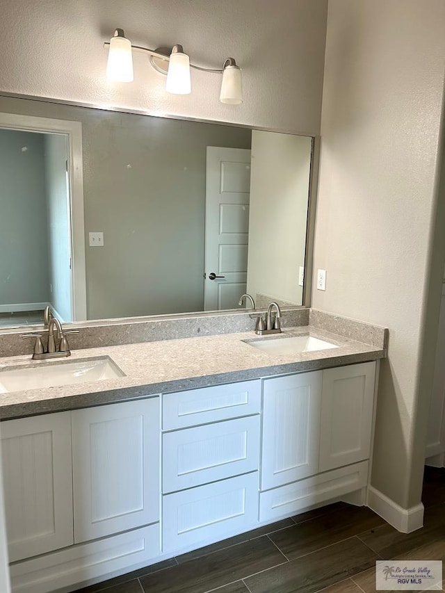 bathroom with vanity and wood-type flooring