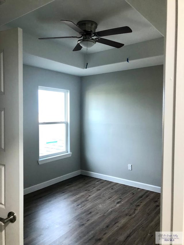 unfurnished room featuring ceiling fan and dark hardwood / wood-style flooring