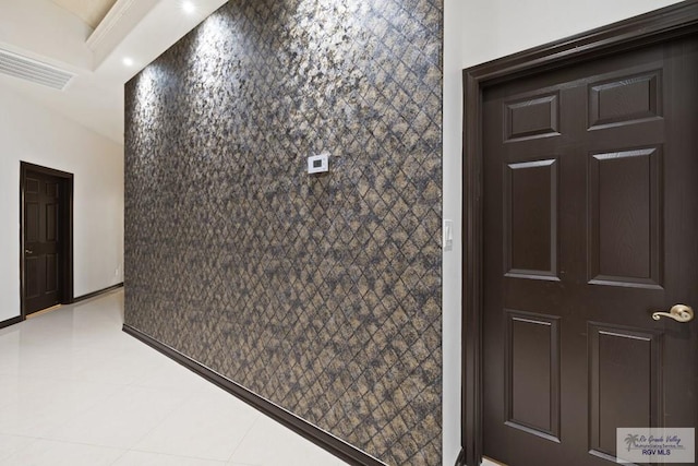 interior space featuring light tile patterned floors and tile walls