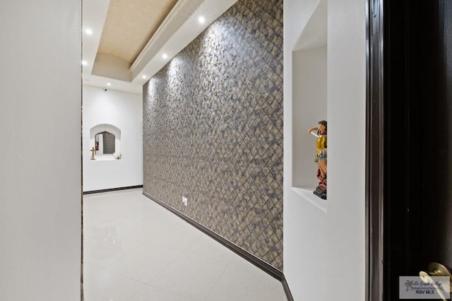 hallway featuring tile patterned floors and tile walls