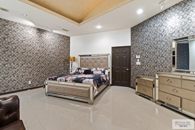 bedroom featuring track lighting, tile walls, and light tile patterned flooring