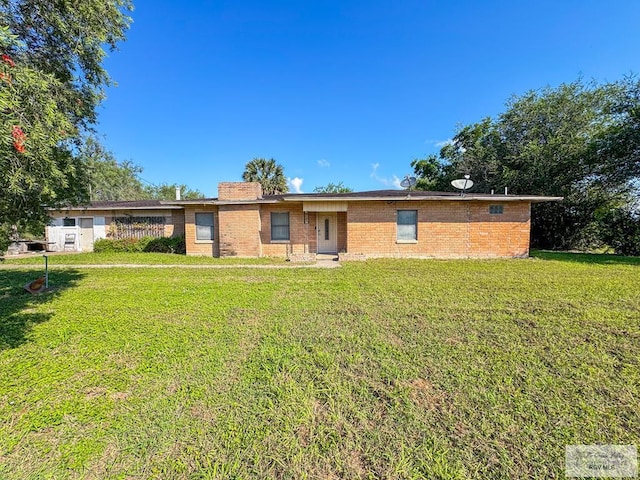 ranch-style house with brick siding and a front yard