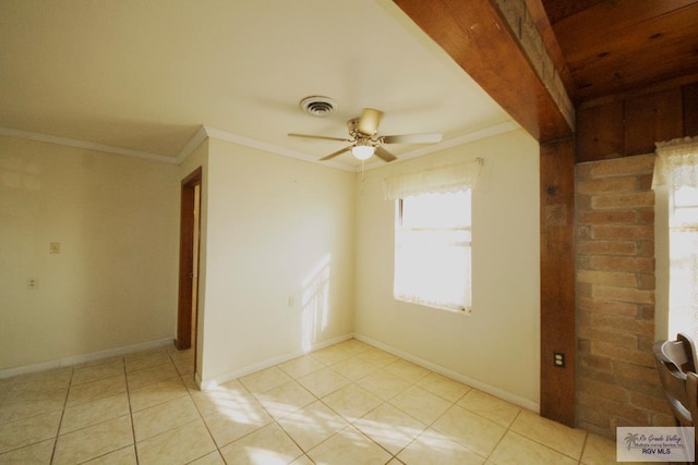 unfurnished room featuring baseboards, visible vents, and crown molding