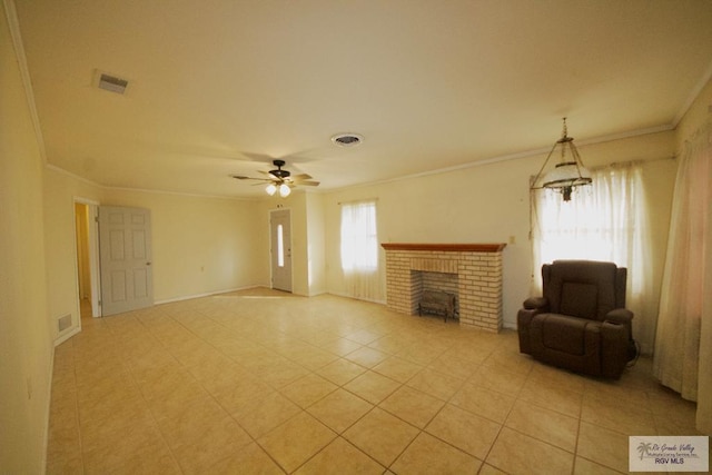 unfurnished living room with ceiling fan, ornamental molding, a brick fireplace, and light tile patterned floors