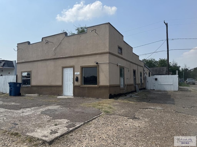 1000 Combes St, San Benito, TX 78586 - rear view of house featuring stucco siding
