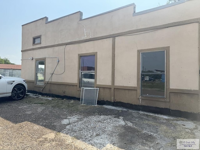 1000 Combes St, San Benito, TX 78586 - view of side of home with stucco siding