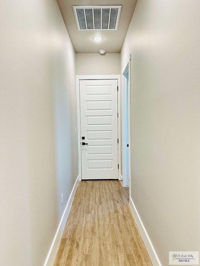 3414 Bryan Dr, Harlingen, TX 78550 - corridor with light wood-style floors, visible vents, and baseboards