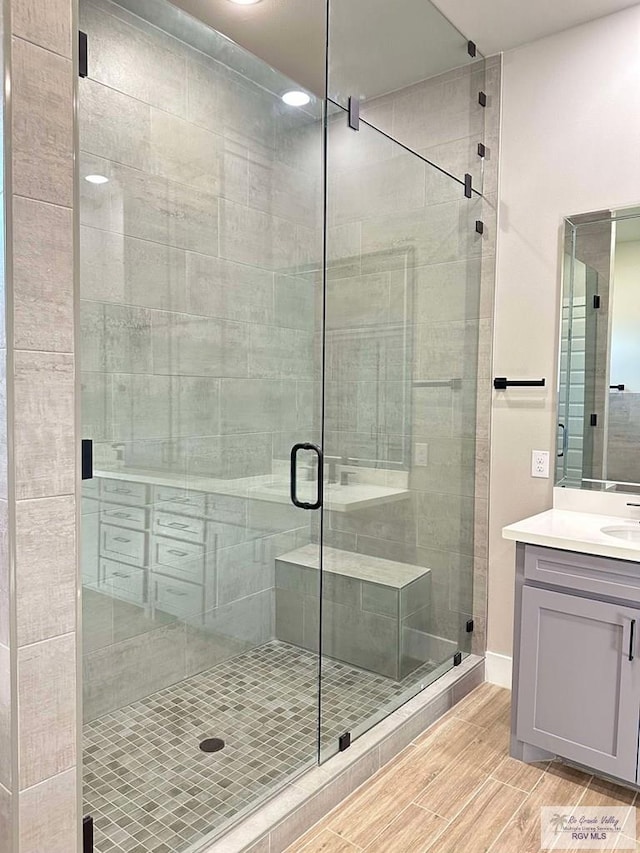 3414 Bryan Dr, Harlingen, TX 78550 - full bath with vanity, a shower stall, and wood tiled floor