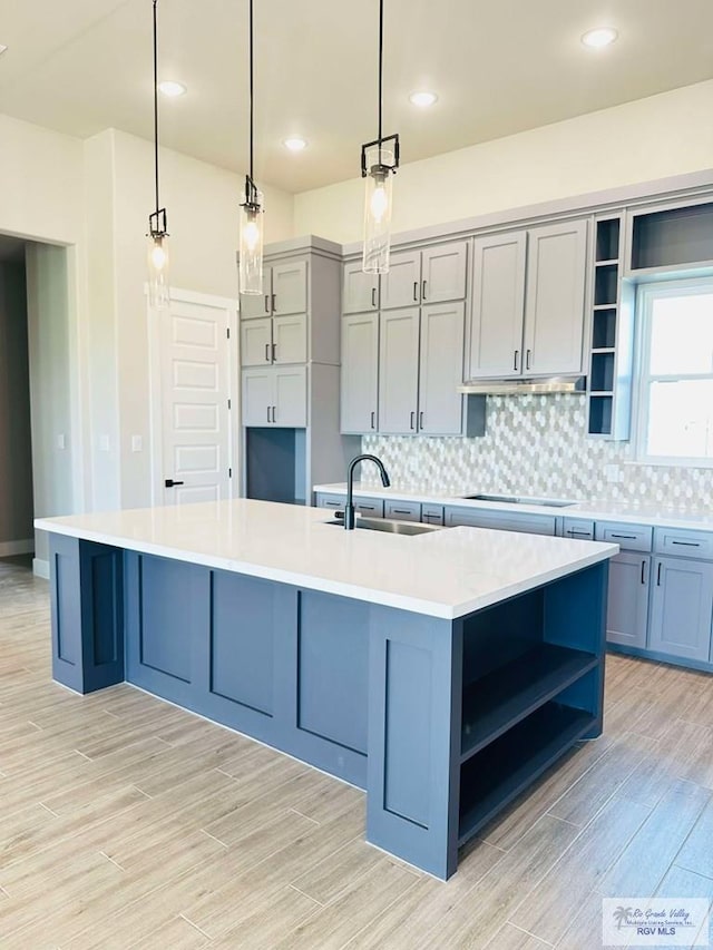 3414 Bryan Dr, Harlingen, TX 78550 - kitchen featuring black electric stovetop, open shelves, a sink, and tasteful backsplash
