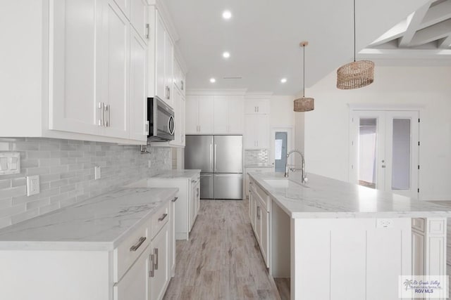 9817 Heights N, Harlingen, TX 78552 - kitchen featuring appliances with stainless steel finishes, a sink, recessed lighting, decorative backsplash, and white cabinets