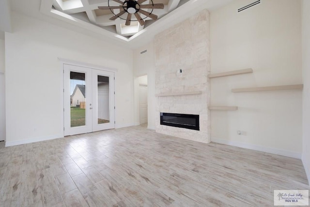 9817 Heights N, Harlingen, TX 78552 - unfurnished living room featuring a towering ceiling, a ceiling fan, wood finished floors, beamed ceiling, and coffered ceiling