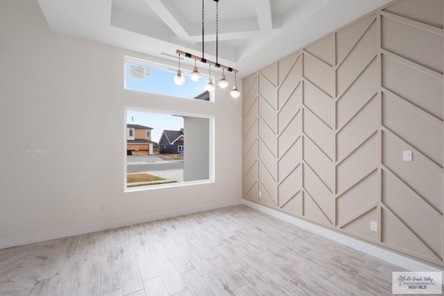 9817 Heights N, Harlingen, TX 78552 - unfurnished room with a raised ceiling, baseboards, and a chandelier