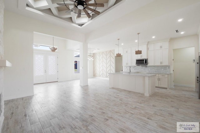 9817 Heights N, Harlingen, TX 78552 - kitchen featuring stainless steel microwave, open floor plan, ceiling fan, light wood-type flooring, and recessed lighting
