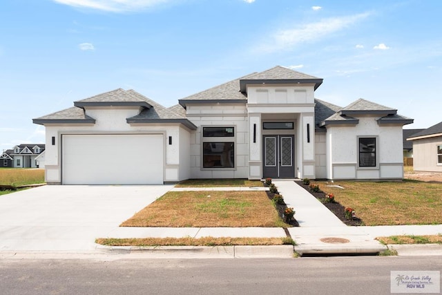 9817 Heights N, Harlingen, TX 78552 - view of front of home with an attached garage, a front yard, concrete driveway, a shingled roof, and french doors