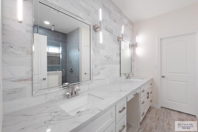 9817 Heights N, Harlingen, TX 78552 - bathroom featuring a stall shower, double vanity, and wood finished floors