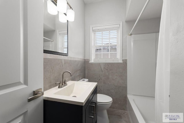 full bath with  shower combination, a wealth of natural light, vanity, and toilet