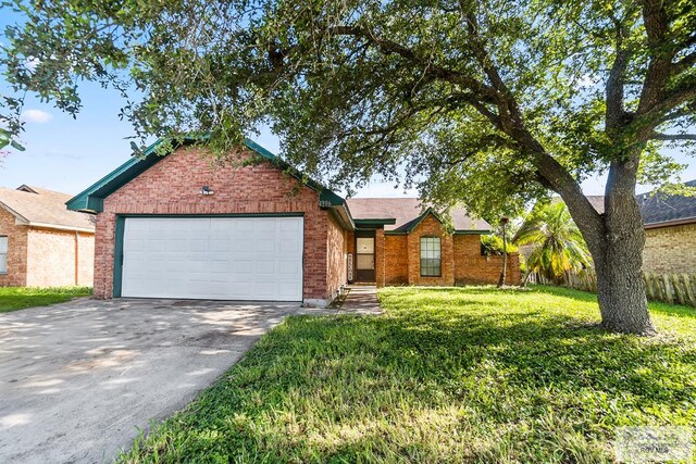 view of front of property with a garage and a front lawn