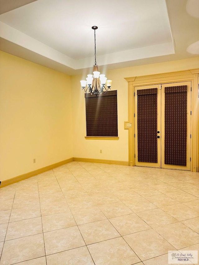 7232 Lago Viejo Blvd, Brownsville, TX 78520 - spare room featuring a chandelier, light tile patterned floors, baseboards, and a raised ceiling