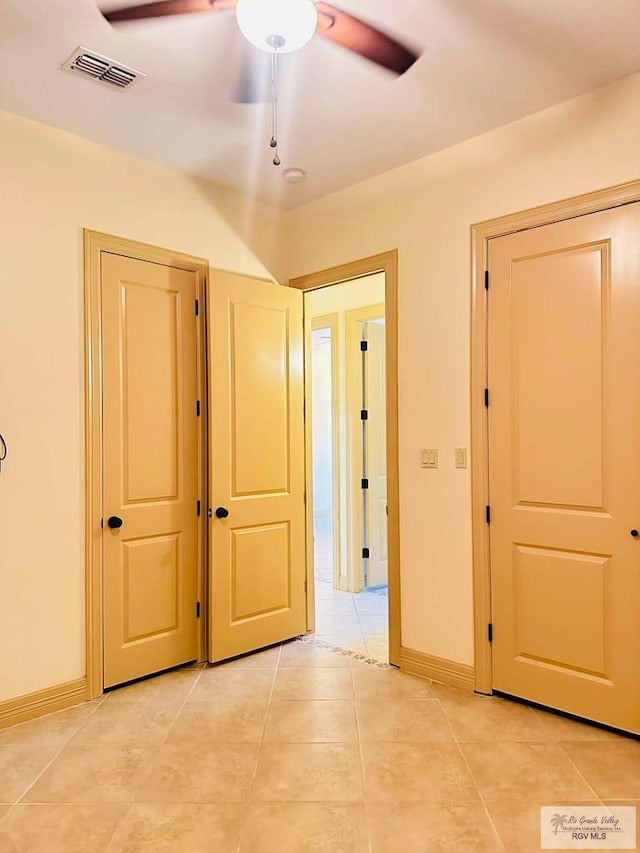 7232 Lago Viejo Blvd, Brownsville, TX 78520 - unfurnished bedroom with light tile patterned floors, baseboards, and a ceiling fan