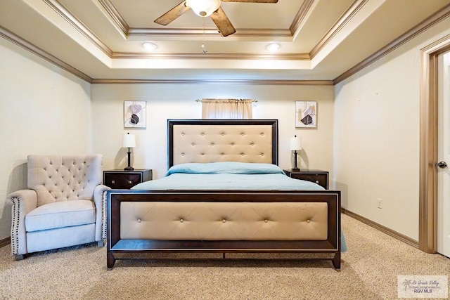 bedroom featuring a tray ceiling, ornamental molding, ceiling fan, and carpet