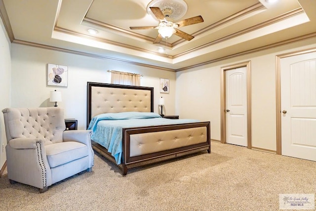 carpeted bedroom with crown molding, ceiling fan, and a tray ceiling