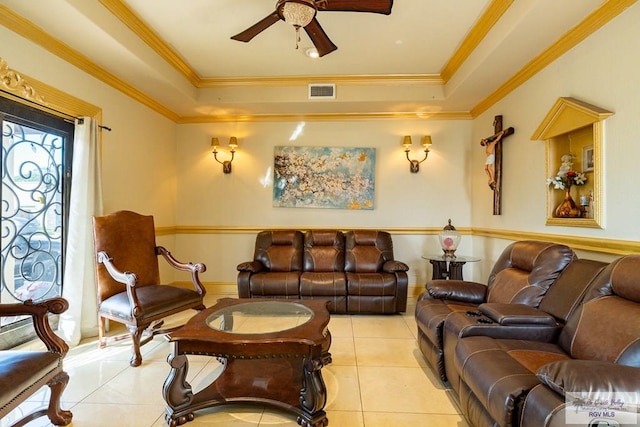 tiled living room featuring crown molding, a raised ceiling, and ceiling fan