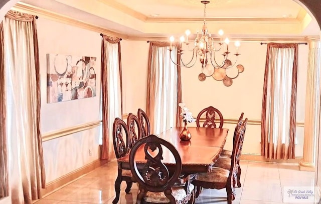 dining space featuring ornamental molding, light tile patterned floors, and a notable chandelier