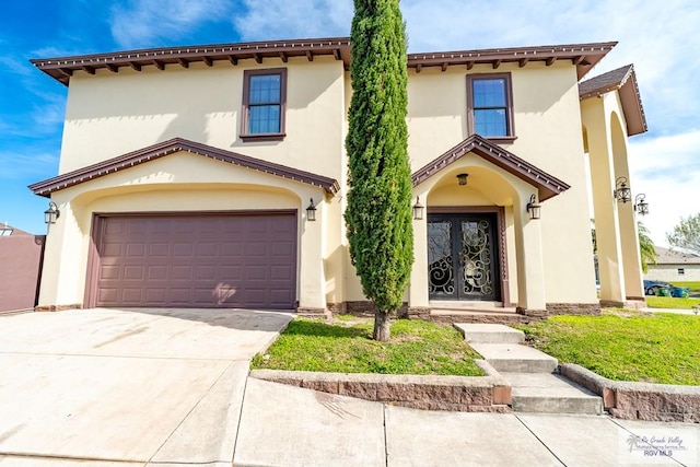 mediterranean / spanish-style home with french doors and a garage